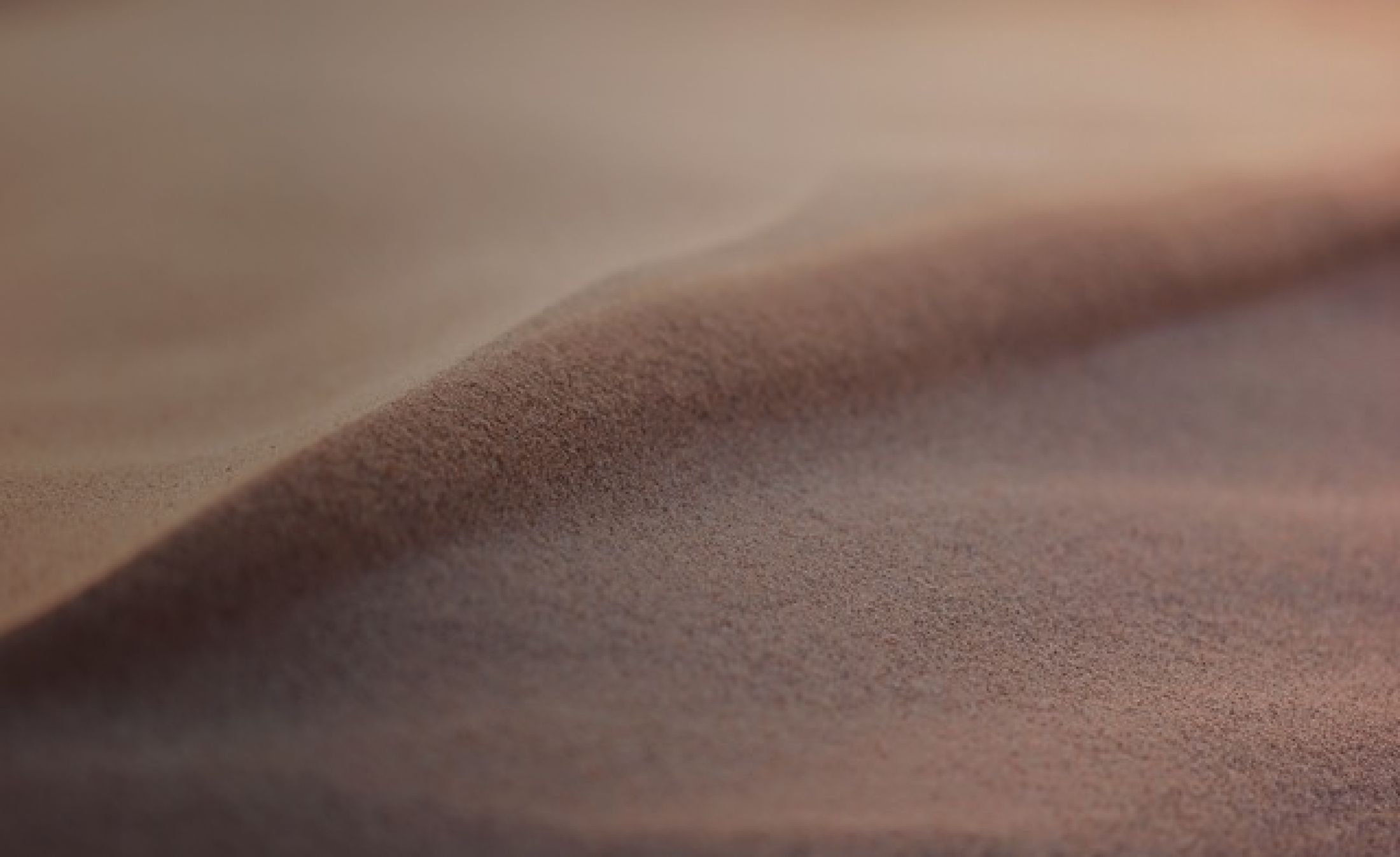 Close-up of soft, wavy sand texture.