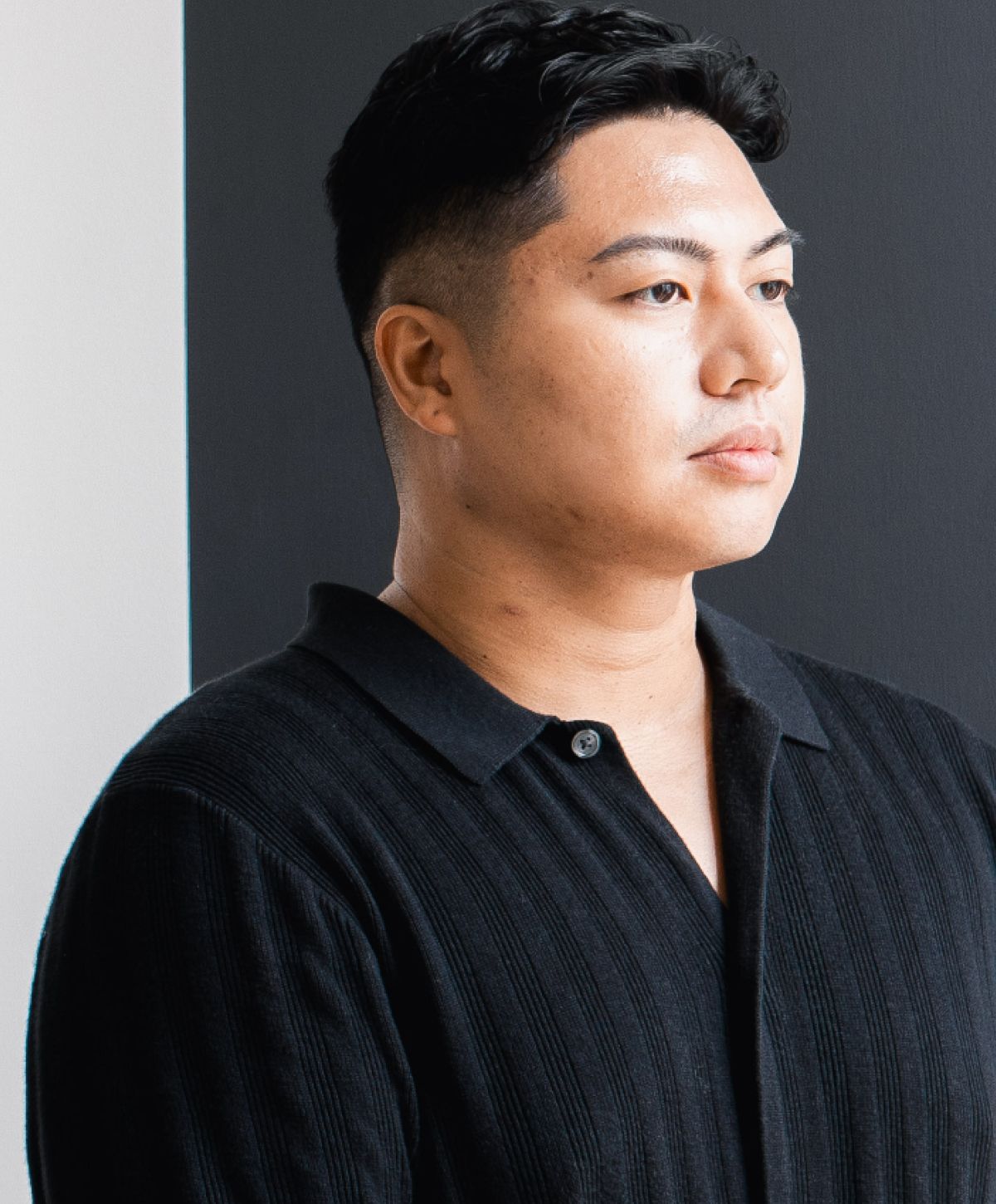 Newport Beach scar revision model in black polo, side profile against background.